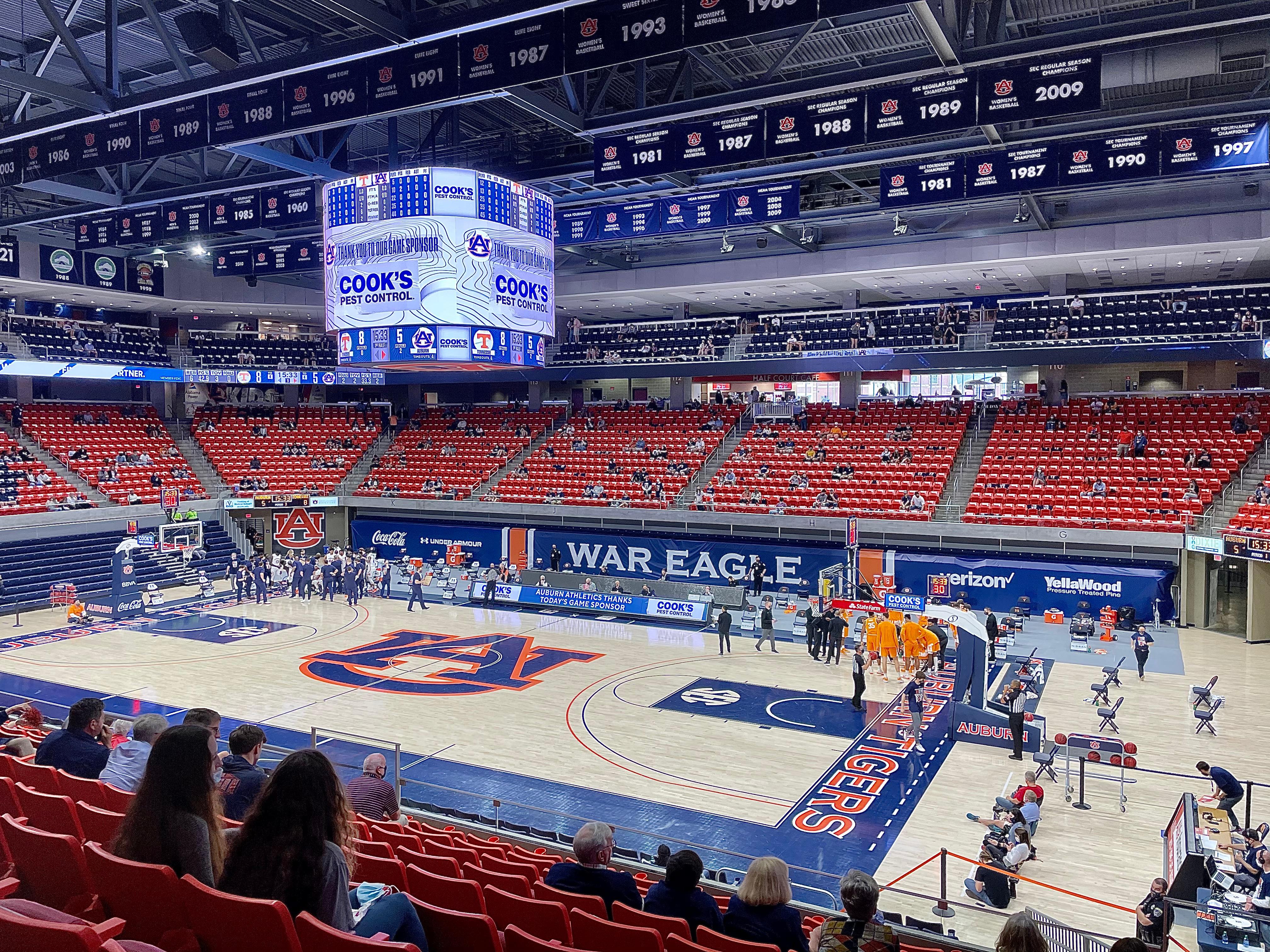 Cook's Pest Control game sponsor signage filling the video board at Auburn Arena