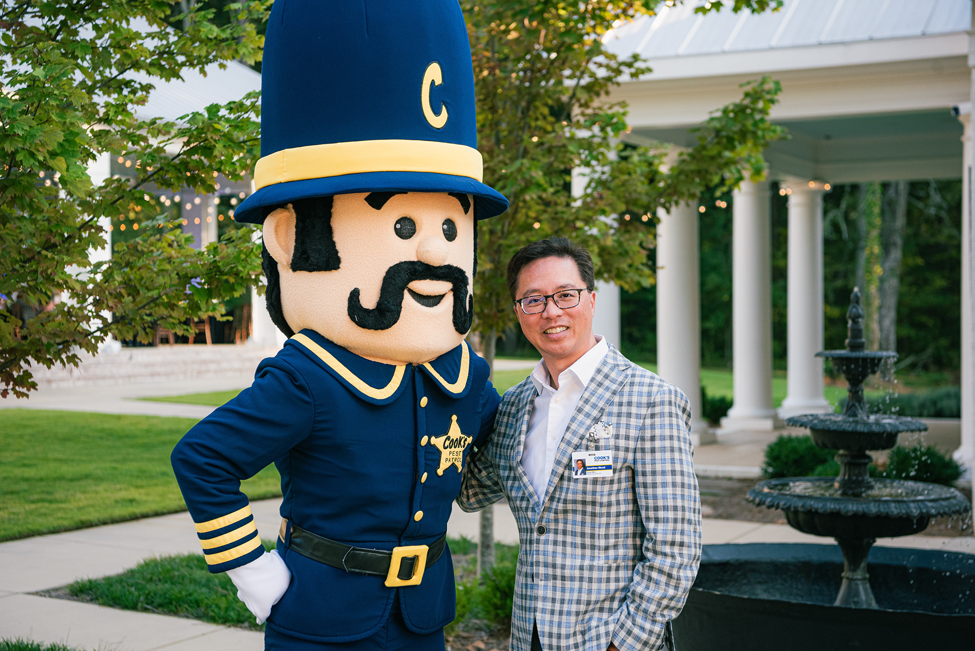 Jonathan Moral with the Cook's Pest Patrol mascot at a company event